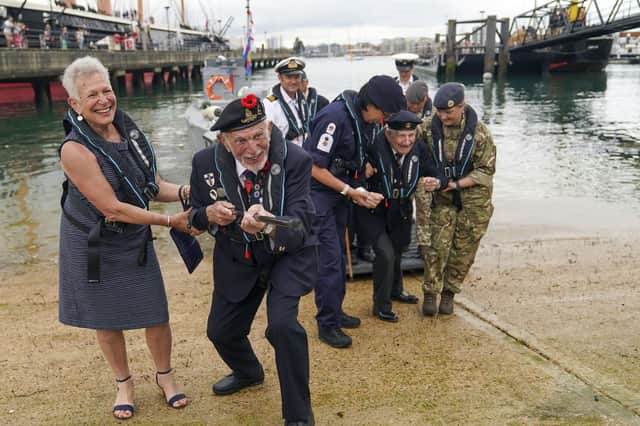 D-Day veteran Joe Cattini raises his walking stick like a machine gun as he and other veterans are welcomed to the Portsmouth Historic Dockyard to commemorate the 77th anniversary of the Normandy Landings. Picture: Steve Parsons/PA Wire