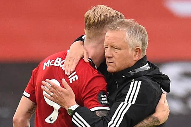 Oliver McBurnie of Sheffield United embraces Chris Wilder, Manager of Sheffield United after the Premier League match between Sheffield United and Tottenham Hotspur at Bramall Lane on July 02, 2020 in Sheffield. (Photo by Oli Scarff/Pool via Getty Images)