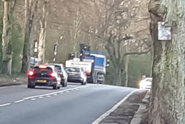 Rivelin Valley Road, Sheffield, was closed this morning after a crash. The picture shows a police car on the right, and a low loader at the bottom of Hagg Hill after the incident this morning