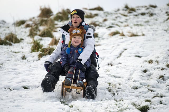 Tanya Hughes and her son Bodhi enjoy the snow in Holyrood Park