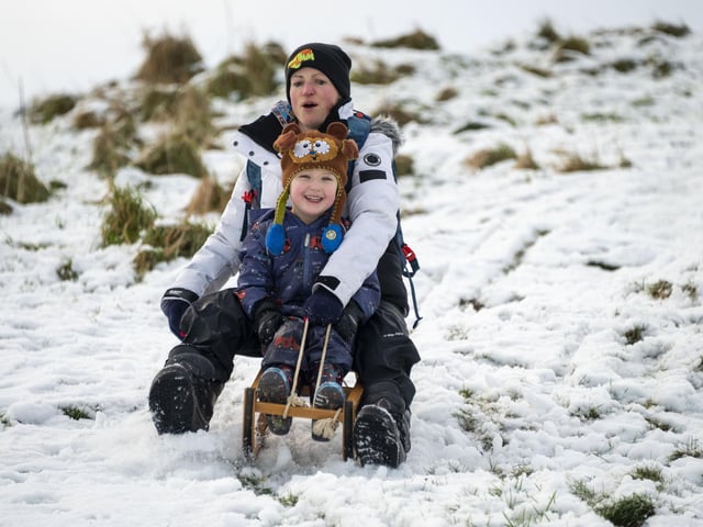 Tanya Hughes and her son Bodhi enjoy the snow in Holyrood Park