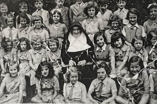 Mylnhurst teacher Sister Scholastica with eight-year-old boys and girls of the junior form in 1938