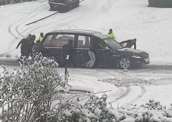 The East Herringthorpe residents were spotted rescuing the hearse in the snow
