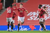 Manchester United's Harry Maguire (centre) celebrates with Axel Tuanzebe after scoring their side's equalising goal against SHeffield United during the Premier League match at Old Trafford