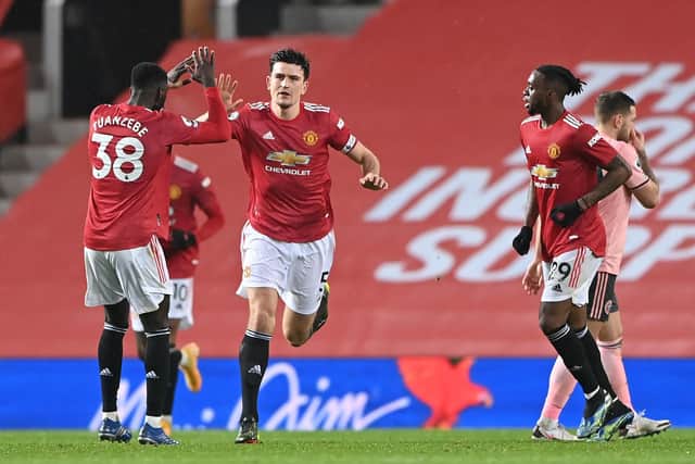 Manchester United's Harry Maguire (centre) celebrates with Axel Tuanzebe after scoring their side's equalising goal against SHeffield United during the Premier League match at Old Trafford