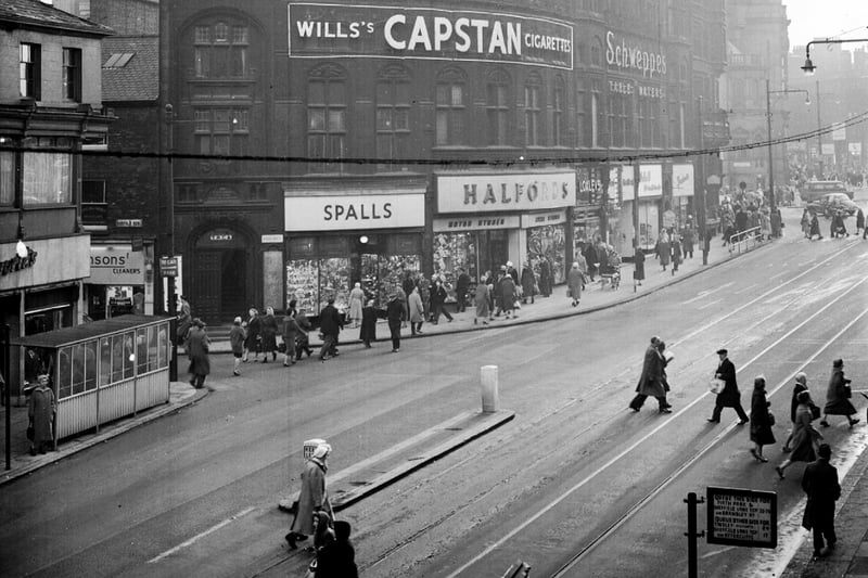 An old view of Fargate showing a bus stop and Halford's motor spares and Spalls on the left