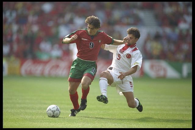 Ricardo Sa Pinto of Portugal is challenged by Tugay Kerimoglu of Turkey in their Group D match at the City Ground.