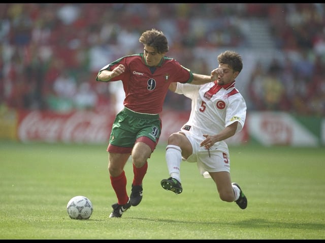 Ricardo Sa Pinto of Portugal is challenged by Tugay Kerimoglu of Turkey in their Group D match at the City Ground.