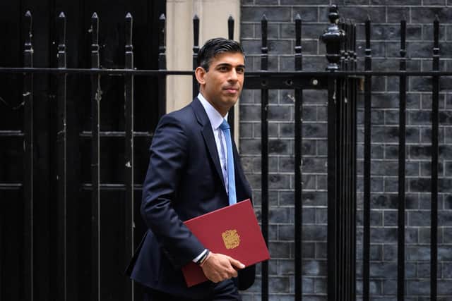 LONDON, ENGLAND - MAY 26: Chancellor Rishi Sunak leaves number 11, Downing Street on May 26, 2022 in London, England. An announcement is expected to be made by Chancellor Rishi Sunak later, knocking hundreds of pounds off domestic energy bills this winter, largely funded by a windfall tax on oil and gas firms that could raise £7bn. (Photo by Leon Neal/Getty Images)
