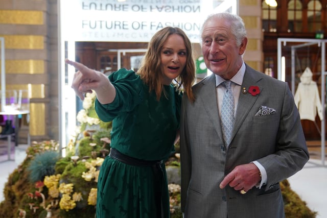 Prince Charles speaks to designer and sustainability advocate Stella McCartney as he views a fashion installation by the designer.