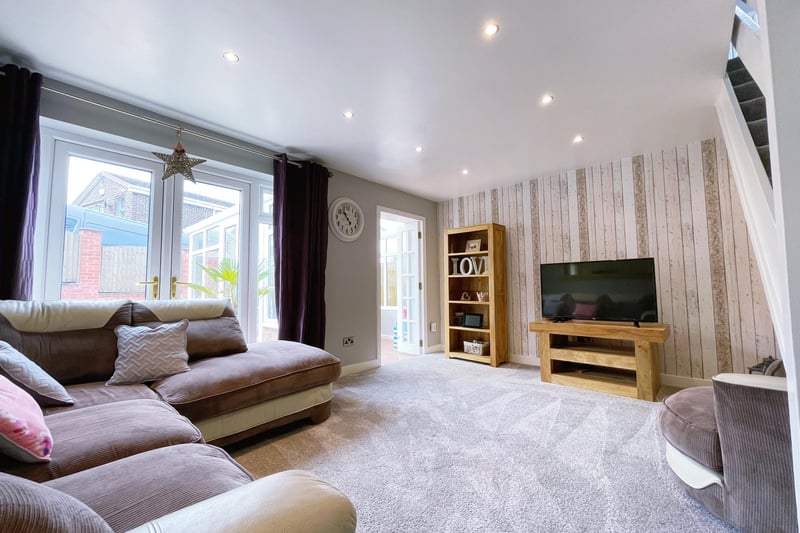 The spacious lounge has patio doors leading to the garden, a central heating radiator, is carpeted throughout and has access to the conservatory.