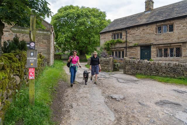 Walkers making their way into the village of Edale in the Peak District. Picture: James Hardisty.