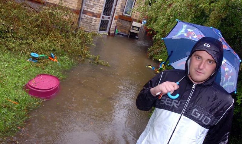 Lee Neath outside his home on Whittington Street fearing that it might flood in 2007.