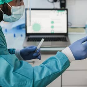 Doctor making swab nasal test to young woman in medical clinic for possible coronavirus infection