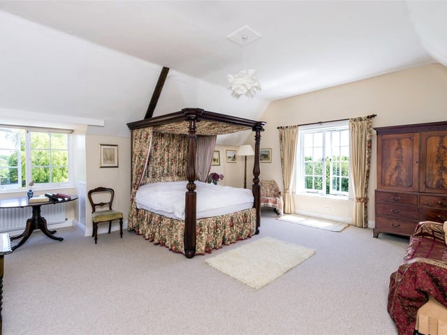 In addition to the generous reception rooms there is a large kitchen/family room complete with open fireplace and large bay window looking out over the surrounding grounds.