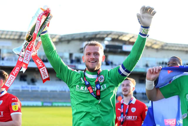 Adam Davies celebrates with the second place trophy after getting promoted following during the Sky Bet League One match between Bristol Rovers and Barnsley at Memorial Stadium on May 04, 2019  (Photo by Harry Trump/Getty Images)