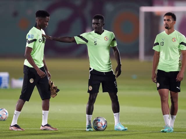 Senegal's Idrissa Gueye with Moussa N'Diaye (left) and Iliman Ndiaye (right) as Aliou Cisse's men prepare for their game against England: Martin Rickett/PA Wire.