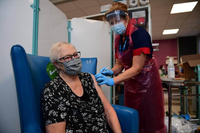 A nurse prepares to administer the Pfizer-BioNTech COVID-19 vaccine to patient Trixie Walker at the Northern General Hospital (Photo by Andy Stenning - Pool/Getty Images)
