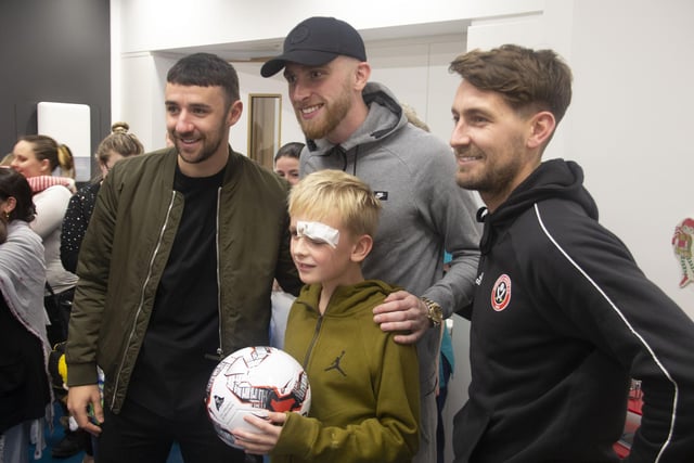 United stars Enda Stevens and Oli McBurnie with a young patient at Sheffield Children's Hospital in December 2019.