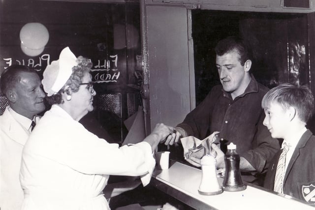 Some things never change, like the joy of a good fish supper. Pictured here is Edith Allen serving fish and chips in Walter Dixon's fish shop, on London Road, Sheffield, in September 1963