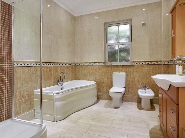 As well as the en suites, the property also features this fantastic family-bathroom, complete with double-width shower cubicle, close-coupled WC, wash hand basin set into a vanity unit, bidet and P-shaped bath. Storage space abounds, and the room is fully tiled.