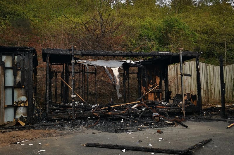 A burnt-out building at the entrance.