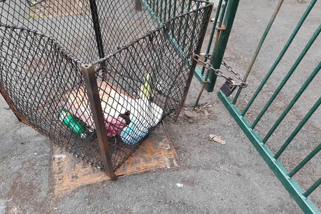 This bin has been chained to railings at Darnall Cemetery after having been  moved and set alight in the past