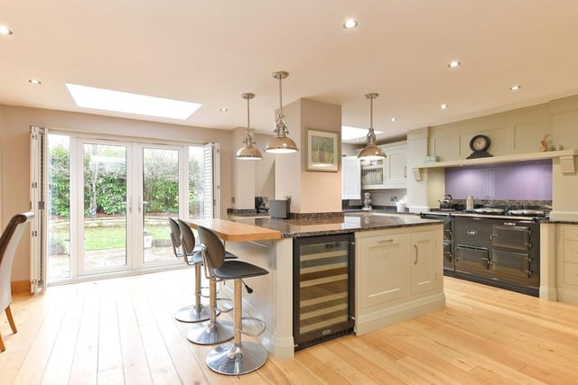 The open-plan kitchen offers separate spaces for cooking and dining. There’s a range of fitted units by David J Martin incorporating matching granite work surfaces, and a Franke Belfast style sink. The central island seats three and appliances include an integrated Siemens dishwasher and a Rangemaster wine cooler.