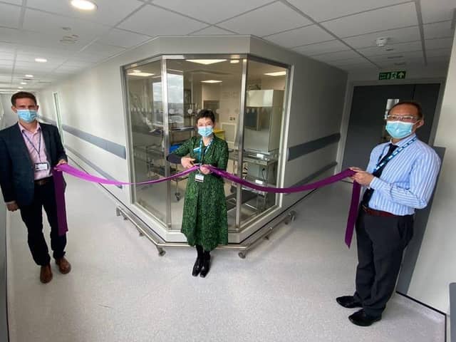 Chief Executive Kirsten Major (centre) with Deputy Chief Pharmacist/Operations Manager Graham Marsh (left) and Principal Pharmacist Keith So (right) at the ceremony. The room in the background is where chemotherapy and immunotherapy treatments are produced.