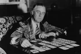Portrait of President Franklin D Roosevelt enjoying a game of solitaire before retiring for the night, May 3rd 1933. (Photo by Keystone Features/Hulton Archive/Getty Images)