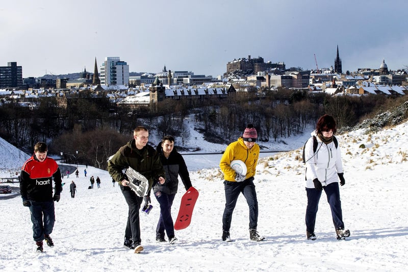 Snowboarders climb Arthur's Seat for a chance to enjoy the snow.