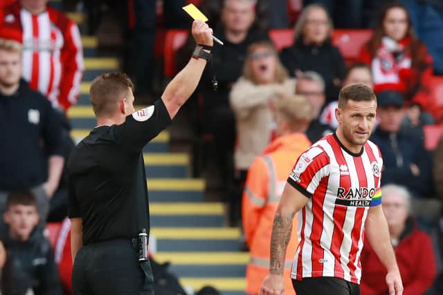 Sheffield United captain Billy Sharp receives a yellow card from referee Josh Smith: Lexy Ilsley / Sportimage