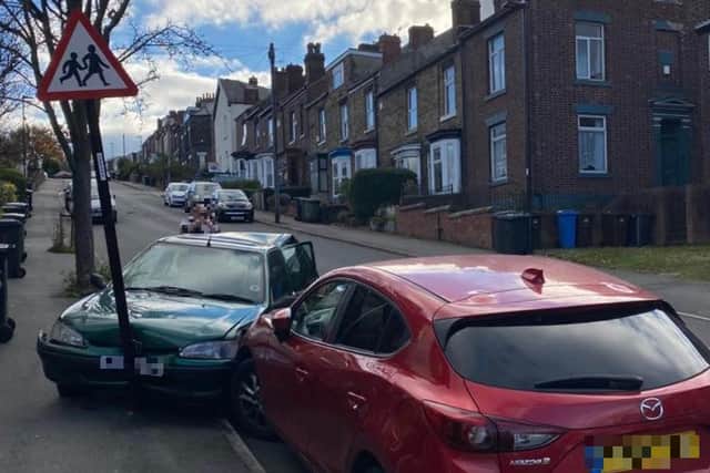 The aftermath of a crash on Myrtle Road in Heeley, Sheffield. The cars pictured were both parked when another car which was reportedly speeding downhill crashed into the green Peugeot, shunting it down the road and into the children crossing sign close to a nursery (pic: Mick Taylor)