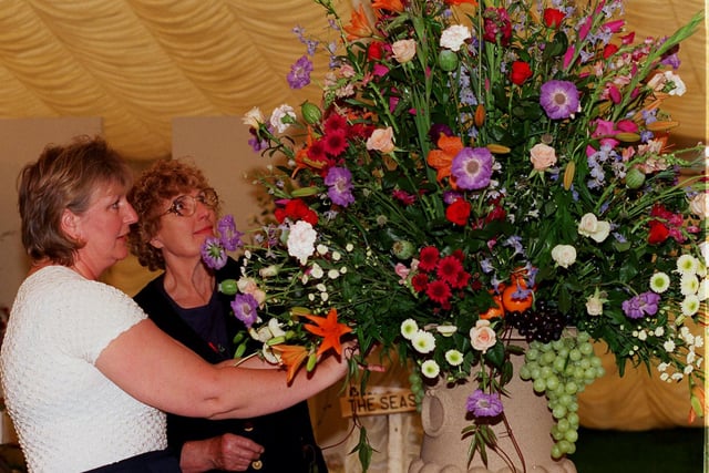 Tanya Asbury and Barbara Bass finely tune one of their floral displays in 1998