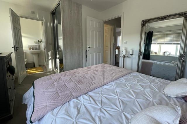 This is the master bedroom from a different angle. Its en suite facilities in the background offer a touch of luxury.