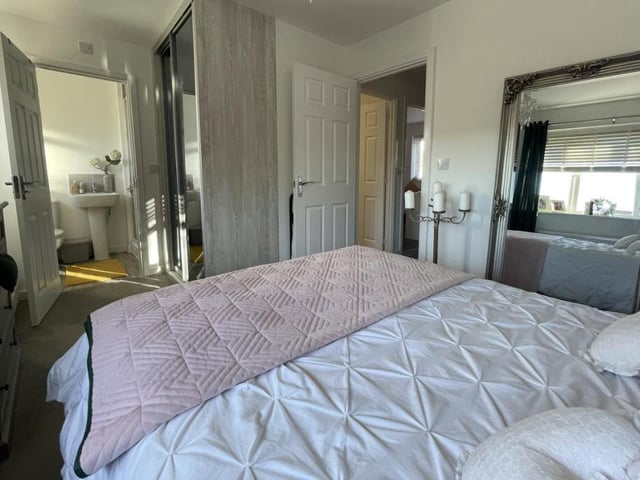 This is the master bedroom from a different angle. Its en suite facilities in the background offer a touch of luxury.