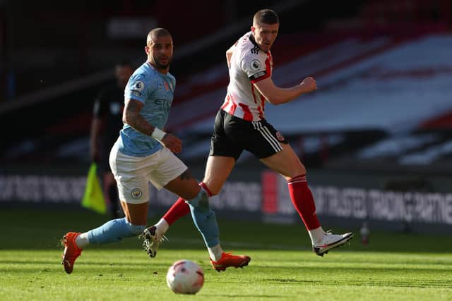 Sheffield United midfielder John Lundstram and former Blade, Manchester City's Kyle Walker, battle for possession at Bramall Lane on Saturday. (Photo by CATHERINE IVILL/POOL/AFP via Getty Images)