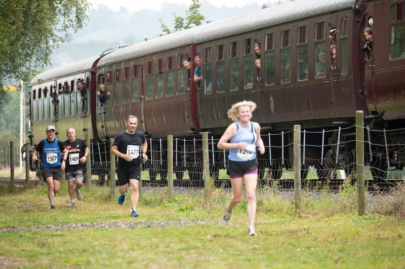 Determined not to be overtaken by the train in the last 200 yards of the race, runners sprint for the finish line.