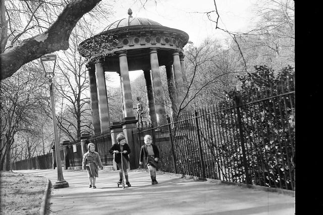 Children playing with a scooter next to St Bernard's Well in April 1960.