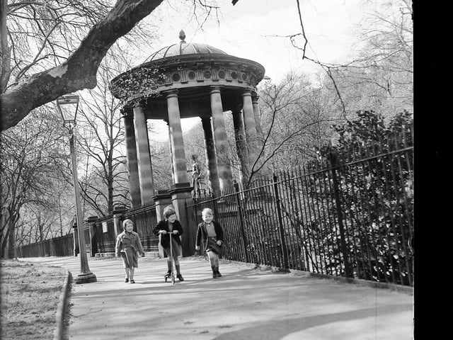 Children playing with a scooter next to St Bernard's Well in April 1960.