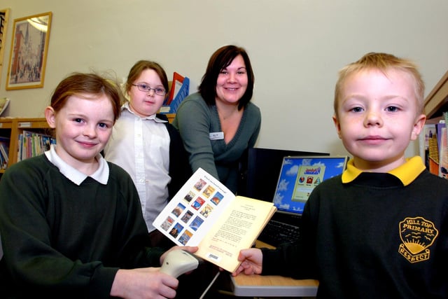 Edlington Hill Top Primary School opened its expanded and updated library in 2007. Our picture shows pupil Curtis Cooper, aged five, taking out a book from the library, young librarians Aimee Pinder (front, left), aged nine, and Tyra Devanney, also aged nine, and teacher Louise Hill.