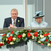 Queen Elizabeth II (C), Prince Andrew, The Duke of York (L) and Prince Philip, The Duke of Edinburgh watch the action from the Queens stand during Derby day at the Epsom Derby Festival (Photo by LEON NEAL / AFP) (Photo by LEON NEAL/AFP via Getty Images)