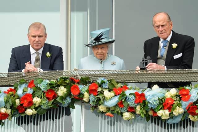 Queen Elizabeth II (C), Prince Andrew, The Duke of York (L) and Prince Philip, The Duke of Edinburgh watch the action from the Queens stand during Derby day at the Epsom Derby Festival (Photo by LEON NEAL / AFP) (Photo by LEON NEAL/AFP via Getty Images)