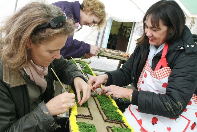 Lynne Allman(back), Jo Wood and Judy Scott-Moncrieff work on the naming board of the Easter themed Hall Well as Tissington prepares for the opening of their Well Dressing festival back in 2008