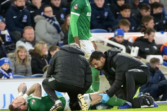 Sheffield Wednesday striker Steven Fletcher receives treatment after suffering a knee injury at Brighton and Hove Albion. Photo: Steve Ellis