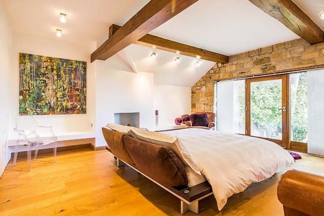 Exposed stone and timber beams catch the eye in one of the property's four bedrooms.