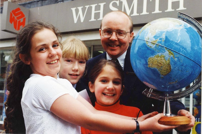 It's Red Nose Day in 1995 and here are the winners of a Red Nose poetry competition organised by WH Smith.  Collecting their trophies from WH Smith manager Ian Hudspith are Rachel Smith, Michelle Shotton and Clare Alaige.