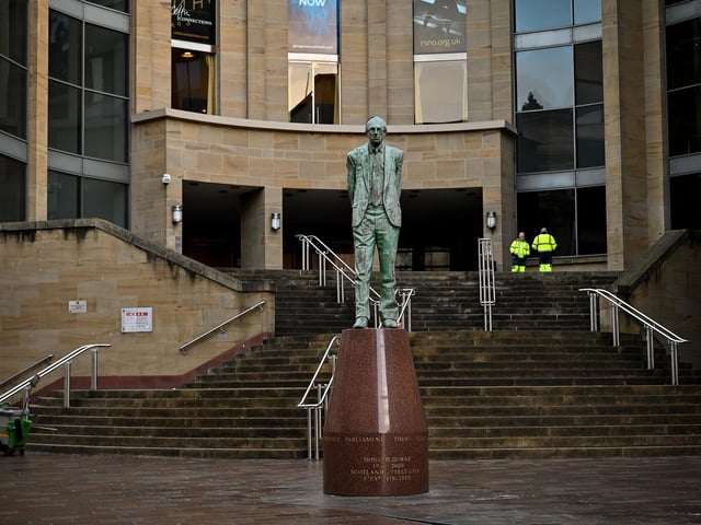 Two members of the public stand around in the virtually empty city centre as new Covid 19 rules come into place on January 5, 2021