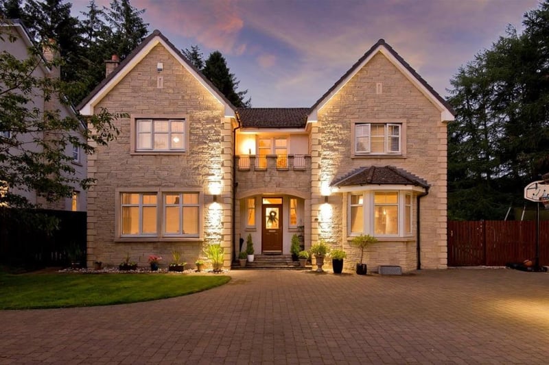 Front of property with exterior lighting.