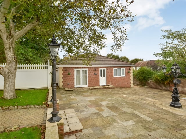 This huge five-bedroom Portsdown Hill home in Portsmouth is up for raffle. Pictured is the property's garden annex, which has two bedrooms, a living room and a kitchenette.